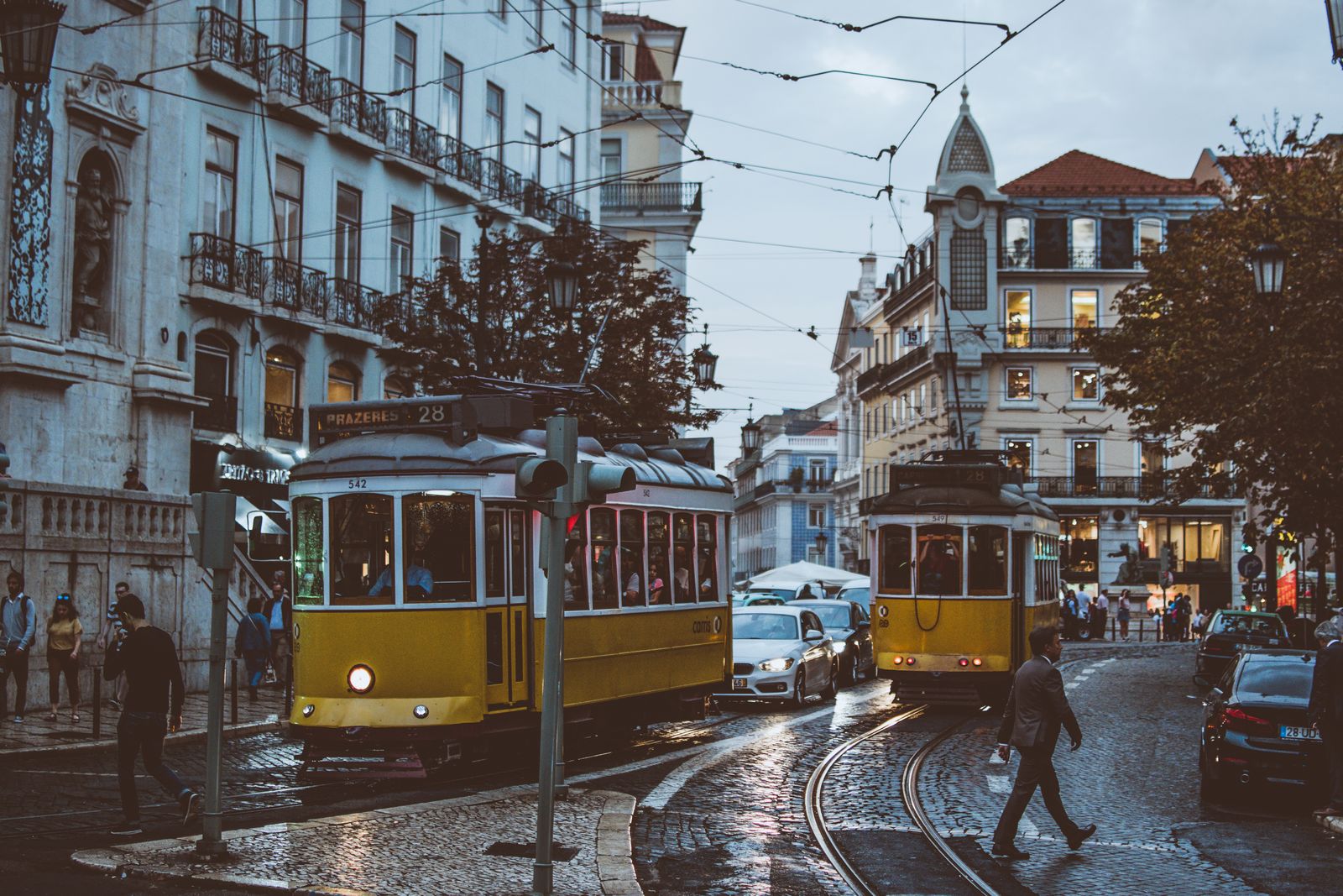 Yellow trams on a cobbled street in central Lisbon, Portugal